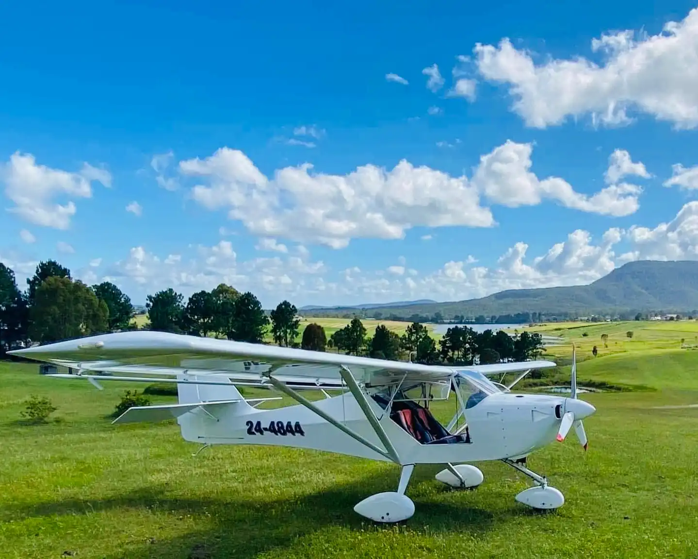 Light sport aircraft on green airstrip
